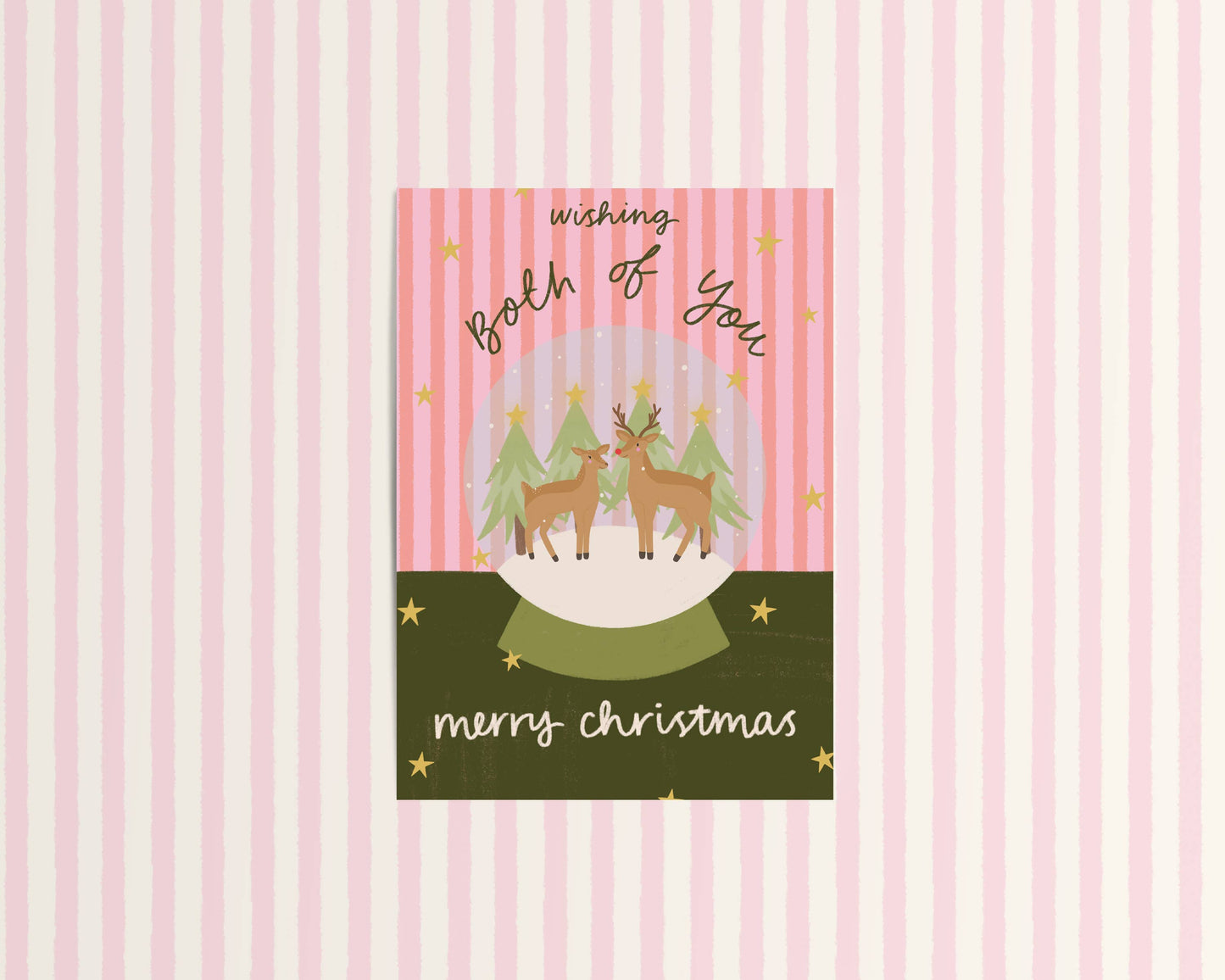 Christmas card with reindeer and trees on a pink and white striped background
