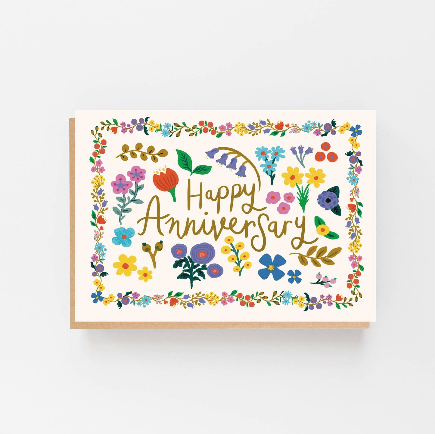 Greeting Card with a bright floral border and in the centre of the border are the words Happy Anniversary surrounded by individual hand drawn flowers. The card is blank inside for your own message and comes with a Kraft envelope.