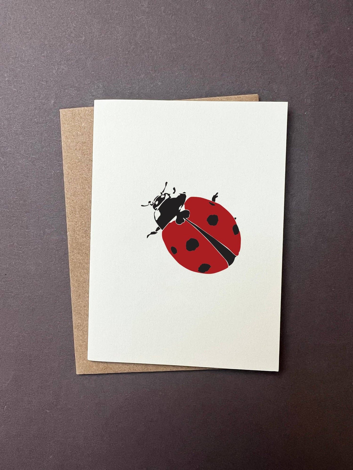 Greeting card with a ladybug design on a white background