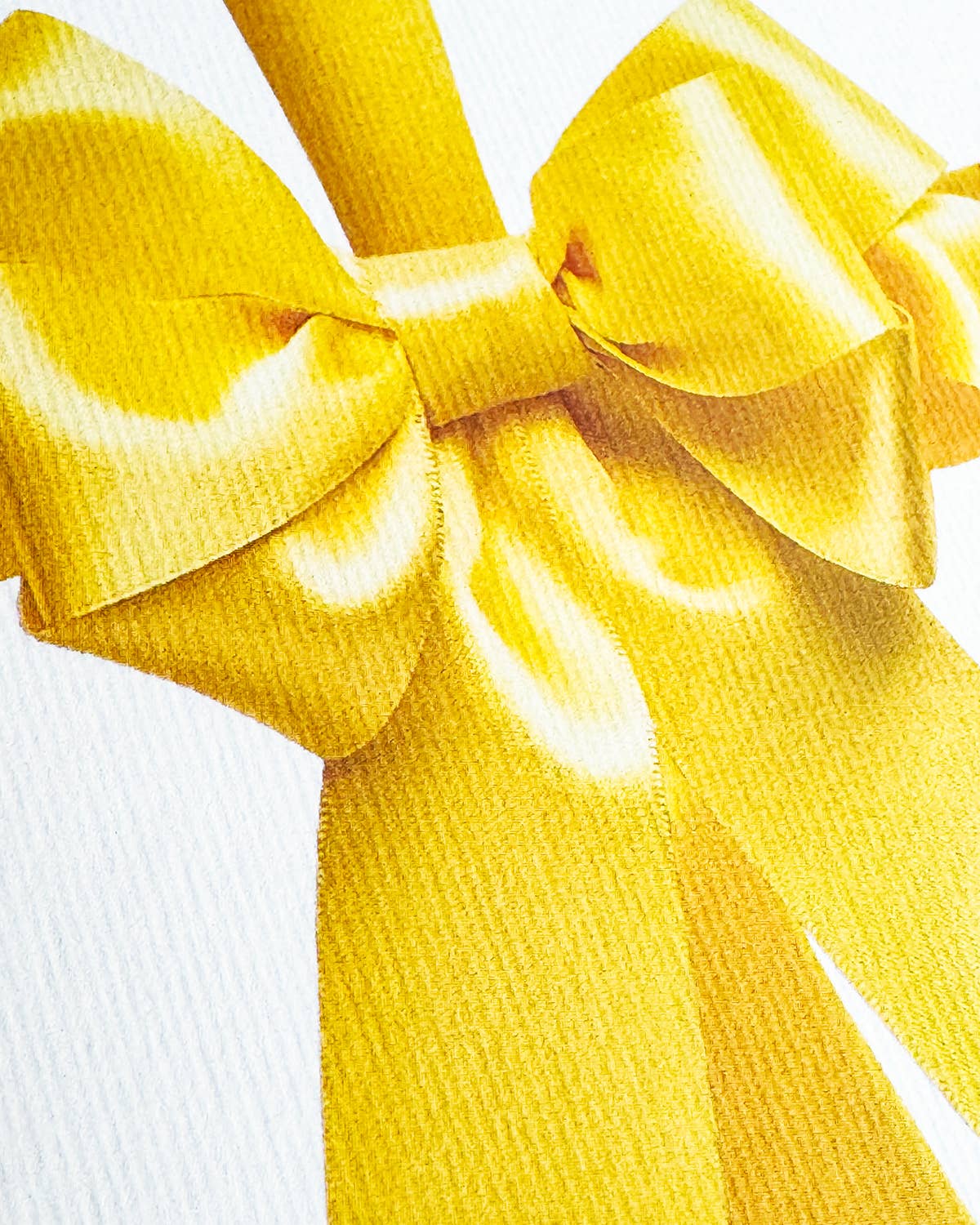 Greetings Card with a Bright yellow Ribbon looking bow on the front. Looks like real material but it is an image White Background. White Envelope.