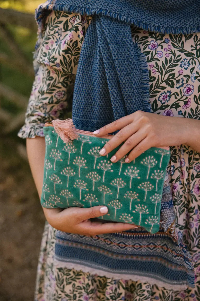 Medium Size pouch in velvet type material in a teal blue with sliver patterned flowers embroidered on the front. There is a pale pink zip with a pale pink tassel.