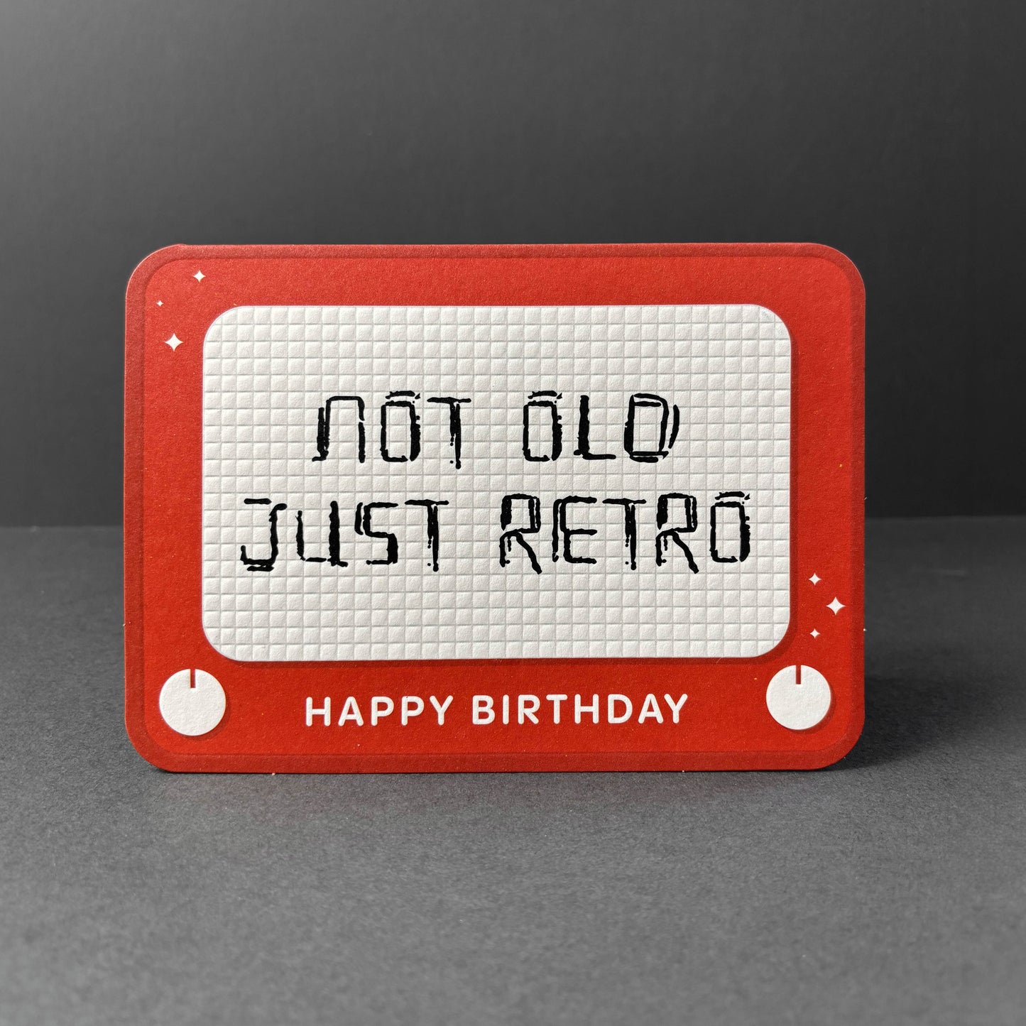 Red and white birthday card with 'Not old just retro' text on a gray background
