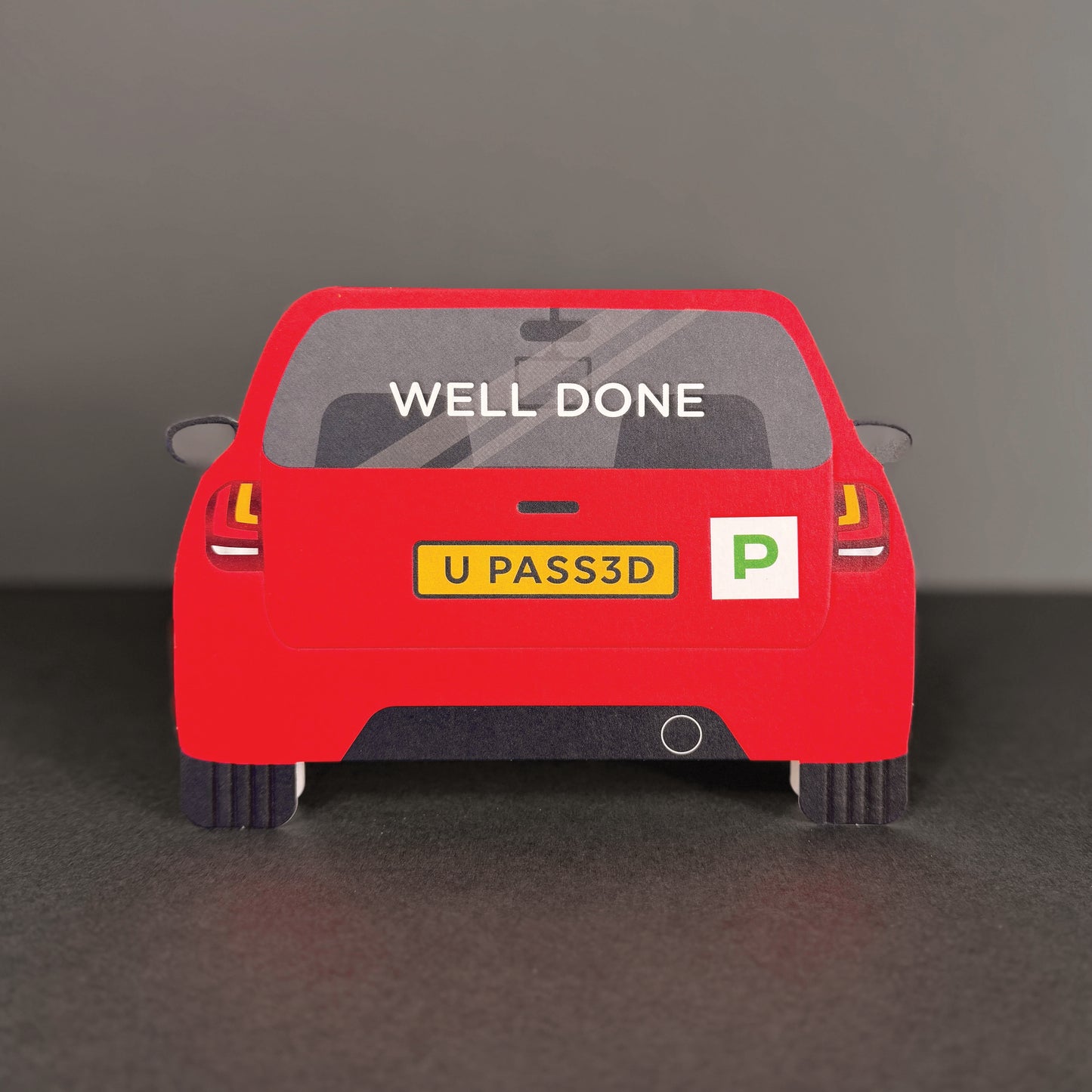 Red car model with 'WELL DONE' text on a dark background