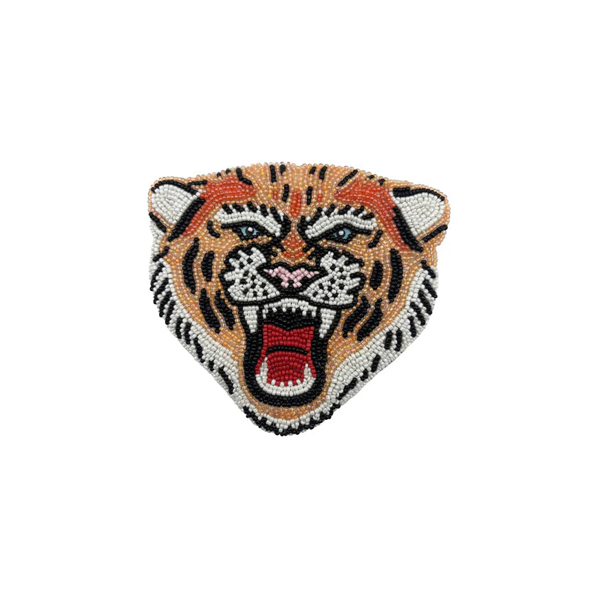 Tiger head purse with beaded details on a white background