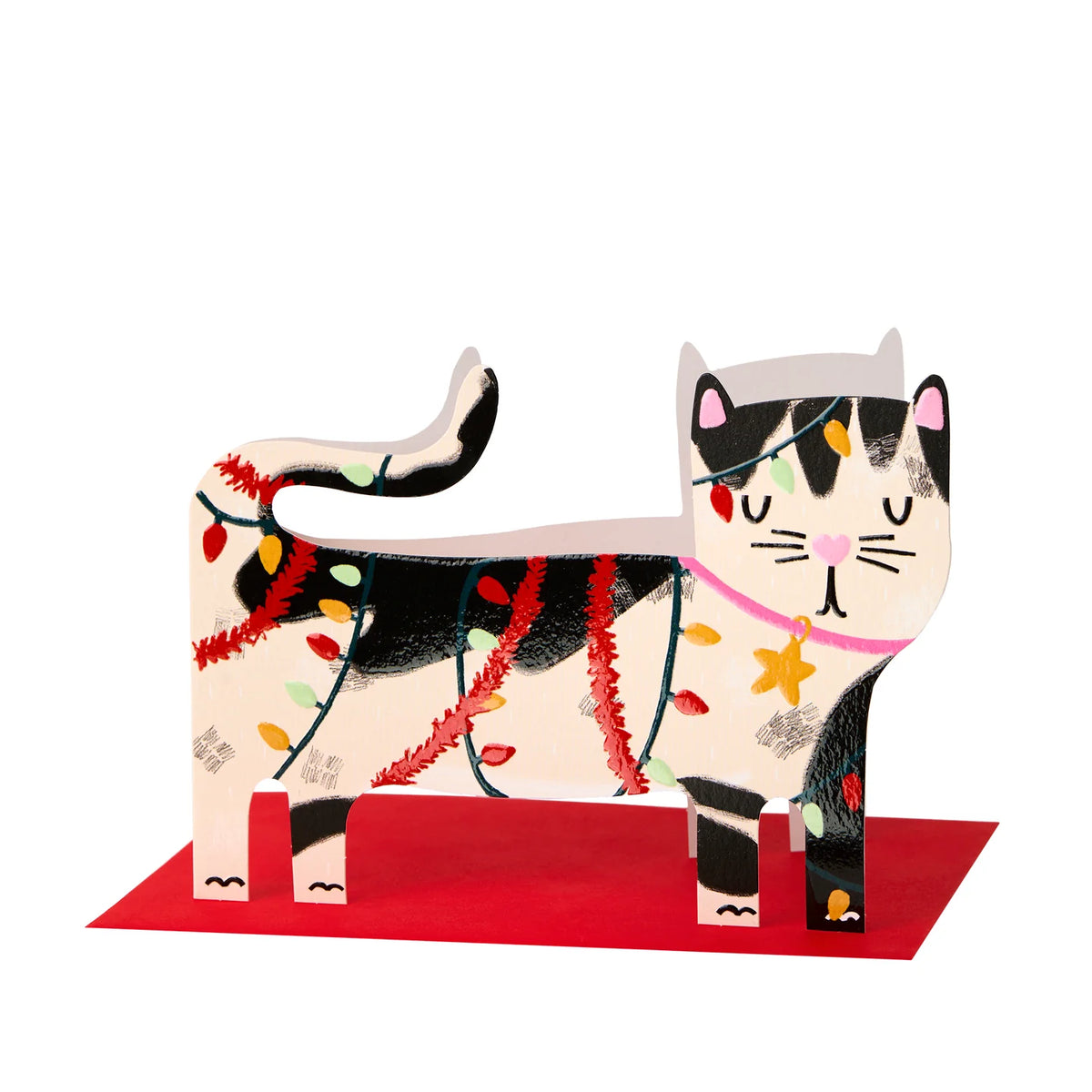 A stylized cat-shaped decorative object standing on a red base, decorated with black and cream sections, pink ears and nose, colorful string lights, and a pink collar, shown on a plain white background.