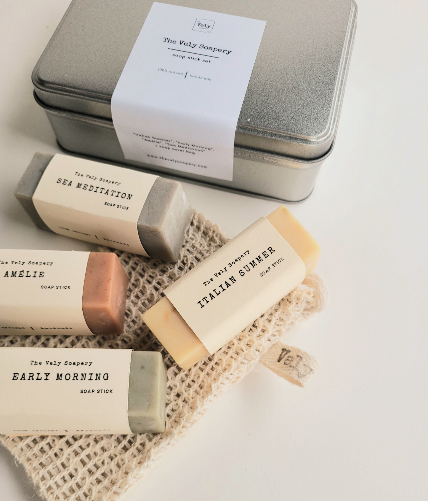 silver metal box which inside are 4 rectangular bars of soap , each a different colours and scents.