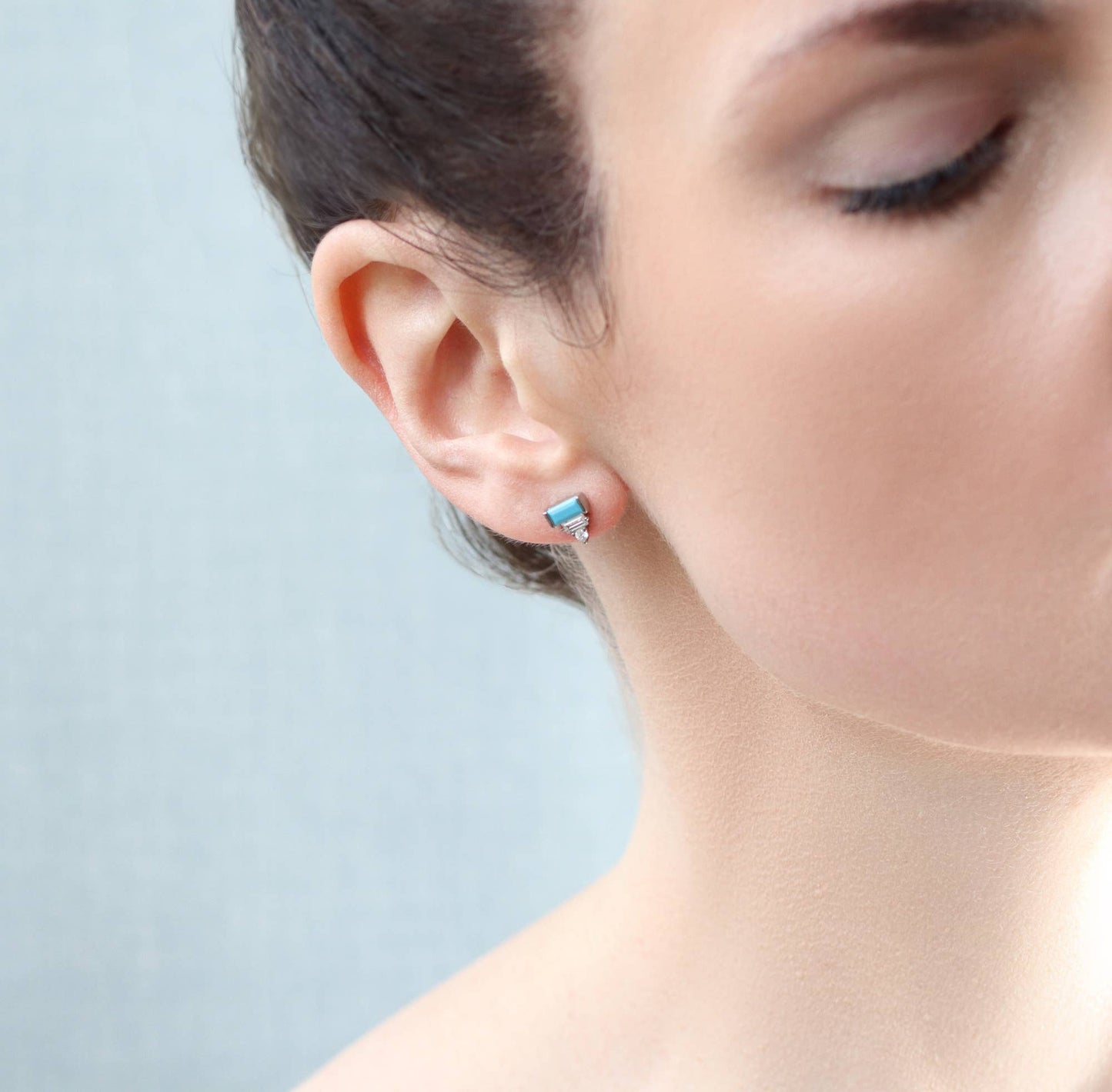 close up image of lady wearing one of the art deco earings