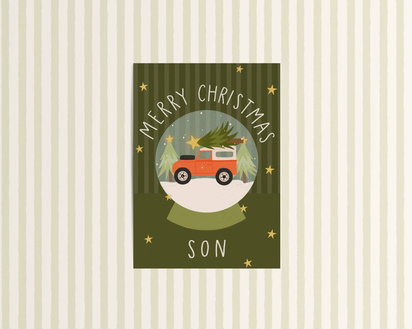 Christmas card with a red truck carrying a Christmas tree, text 'Merry Christmas Son' on a striped background.