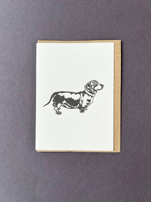 Greeting card with a dachshund illustration on a white background
