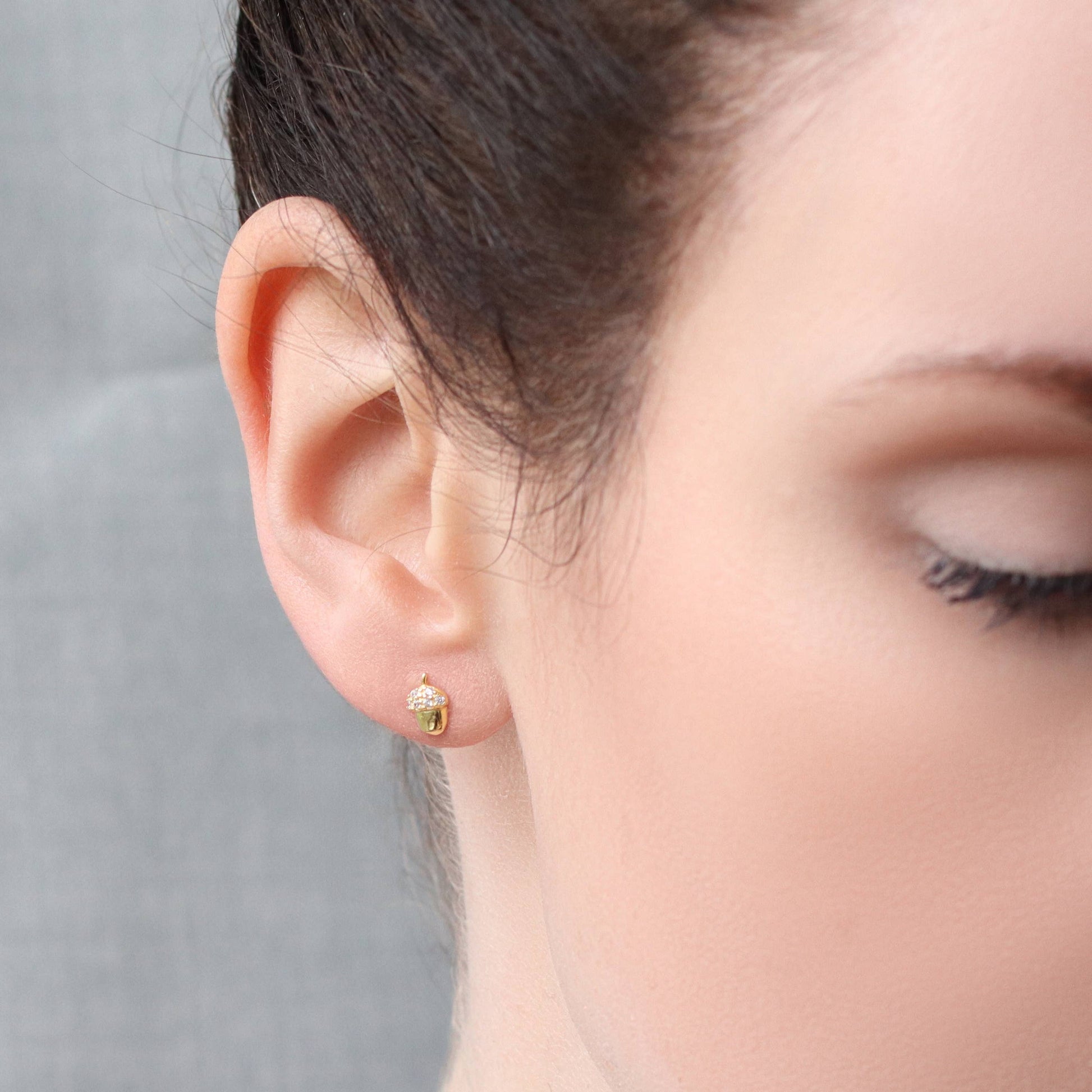 image of a lady wearing one of the acorn earrings