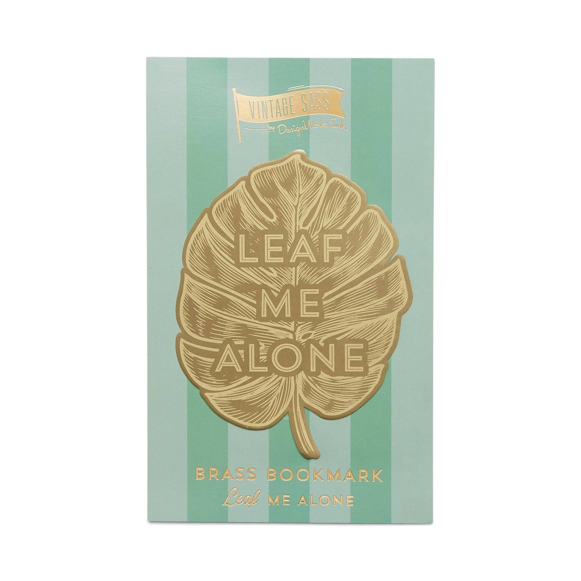 image of a brass bookmark in the shape of a leaf.  etched in the centre of the leaf are the words leaf me alone