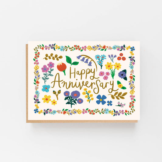 Greeting Card with a bright floral border and in the centre of the border are the words Happy Anniversary surrounded by individual hand drawn flowers. The  card is blank inside for your own message and comes with a Kraft envelope.