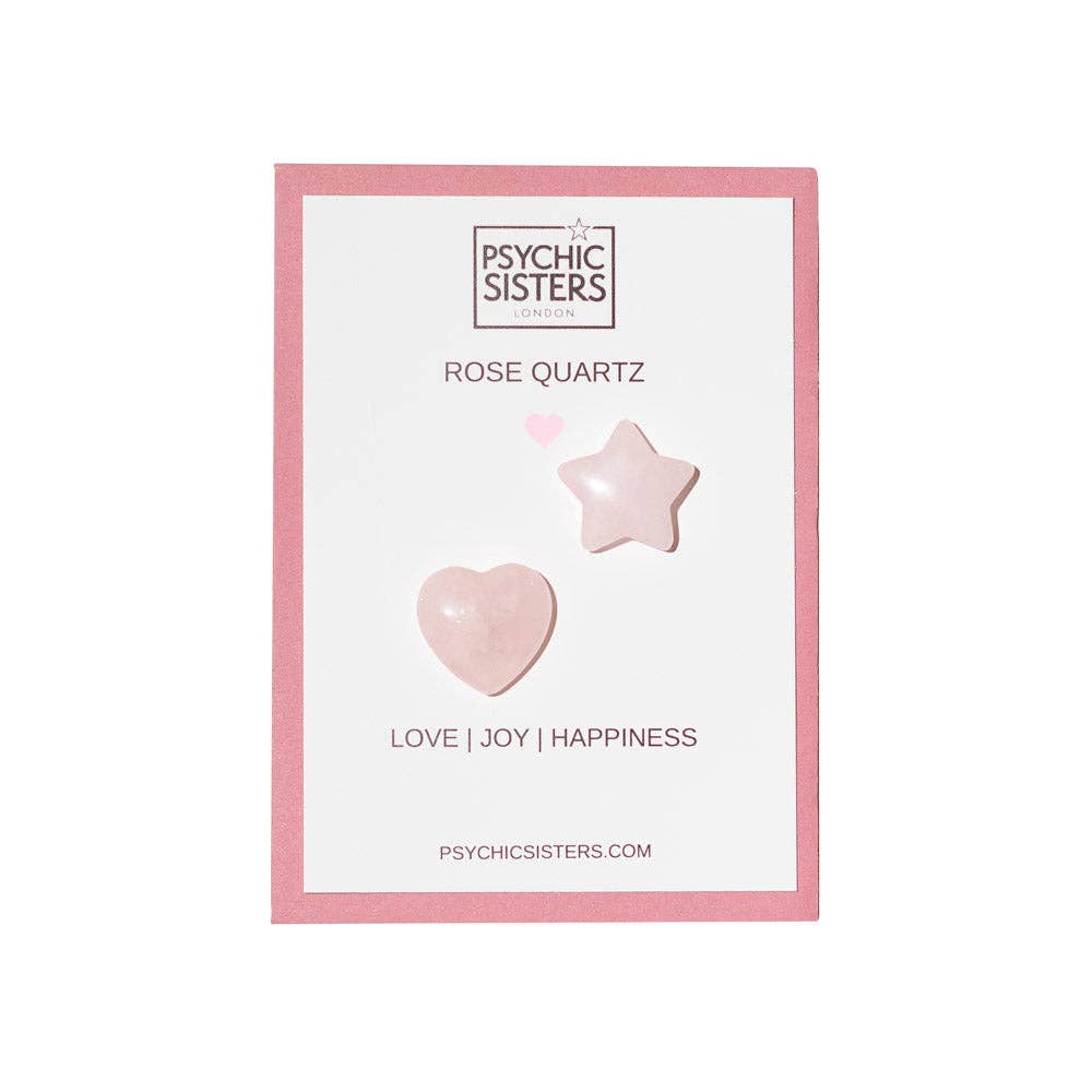  rose quartz crystal stones, one heart-shaped and one star-shaped, displayed on a white backing card with a pink border. The card is branded 'Psychic Sisters' and features the text 'ROSE QUARTZ', 'LOVE | JOY | HAPPINESS', and 'PSYCHICSISTERS.