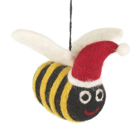 christmas tree hanging decoration of a bee with a black and yellow stripped body and white wings. the bee has a smiley face and is wearing red and white christmas hat