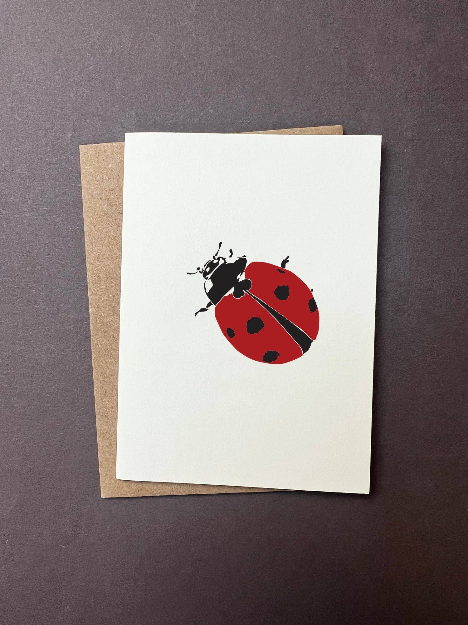 Greeting card with a ladybug design on a white background