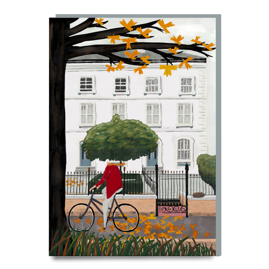Illustration of a person on a bicycle in front of a white building with autumn leaves.