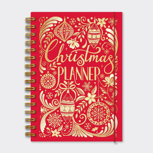 Gold spiral bound red book with gold decorations on the cover and written in gold it states Christmas Planner . There is a piece of red elastic around the right handside of the book.
