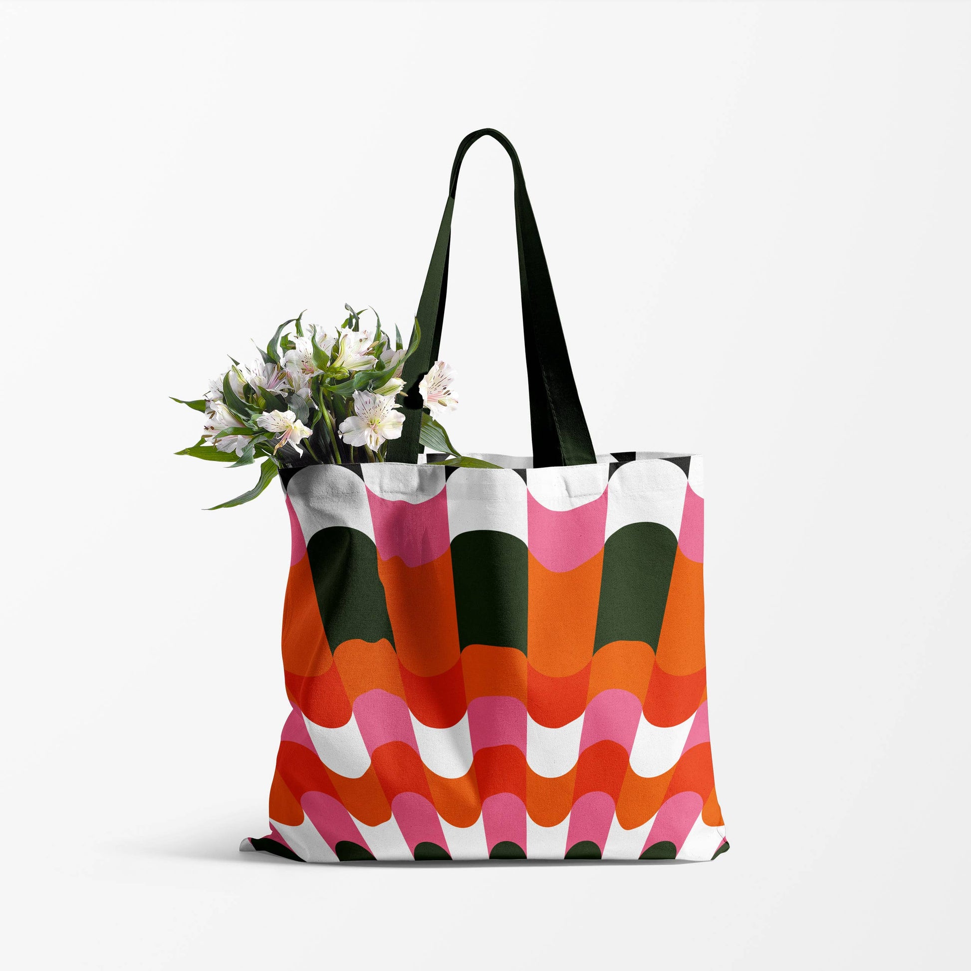 image of a  tote bag with black handles. the body of the bag has a unique retro design using  pink, orange,red and black 