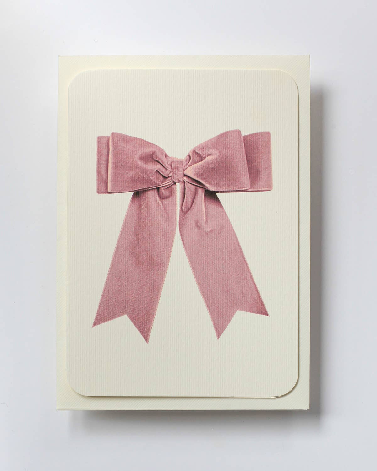 Greetings Card with a Pale Pink Velvet looking Ribbon looking bow on the front.  Looks like real material but it is an image  White Background.  White Envelope