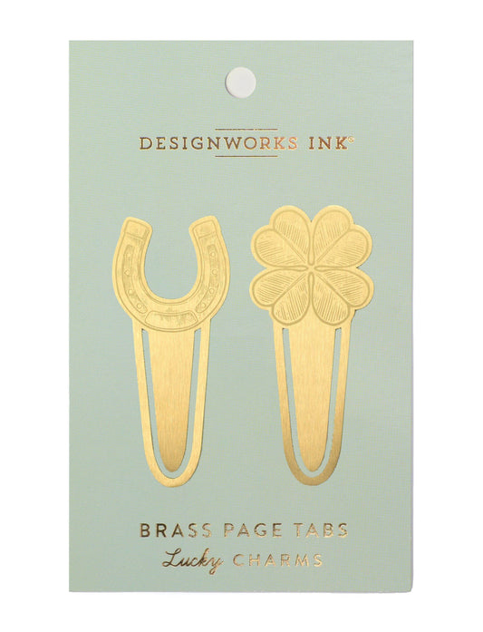 2 brass page markers with one having a horseshoe on the top an the other a four leaf clover