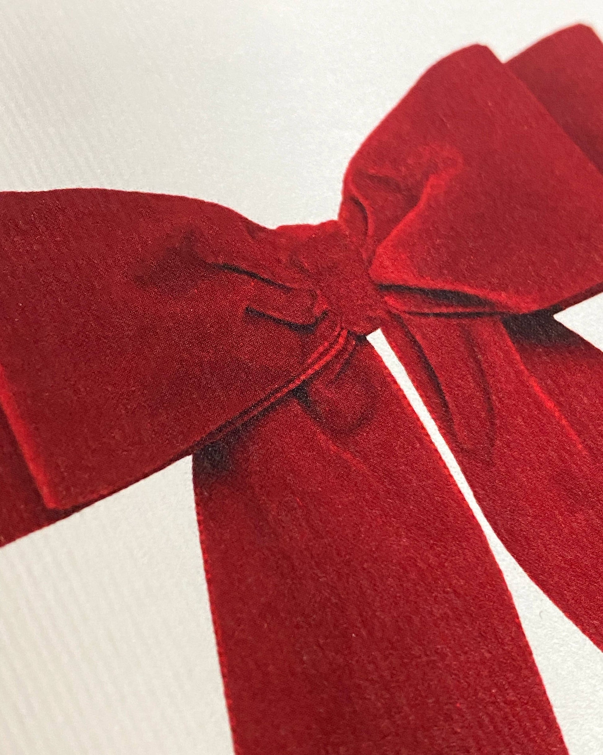 Greetings Card with a Red Velvet looking bow on the front. White Background.    White Envelope.