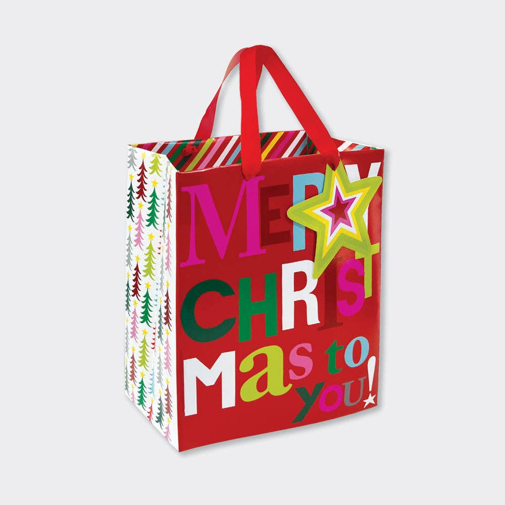 Red Christmas gift bag with colorful text and star design on a white background