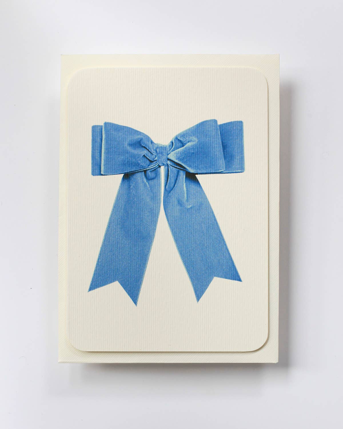Greetings Card with a Pale Blue Velvet looking Ribbon looking bow on the front.  Looks like real material but it is an image  White Background.  White Envelope