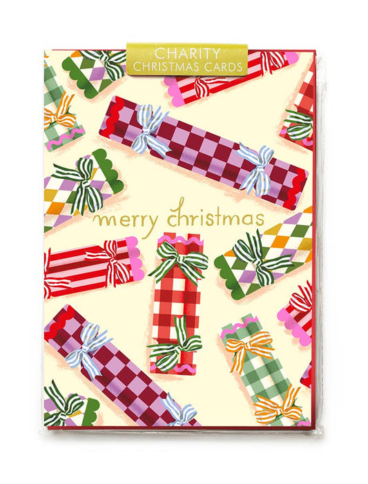 Pack of charity Christmas cards with colorful checkered ribbons on a beige background