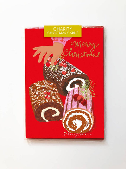 Red box of charity Christmas cards with illustrations of cakes on a white background