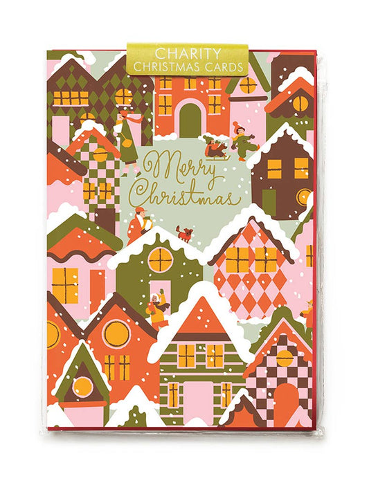 Pack of charity Christmas cards with colorful house illustrations on a white background
