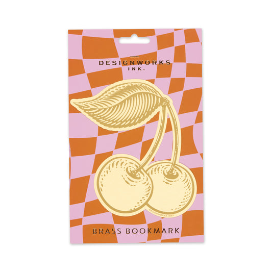Brass bookmark packaging with a checkered pattern and 'Designworks Ink' branding.