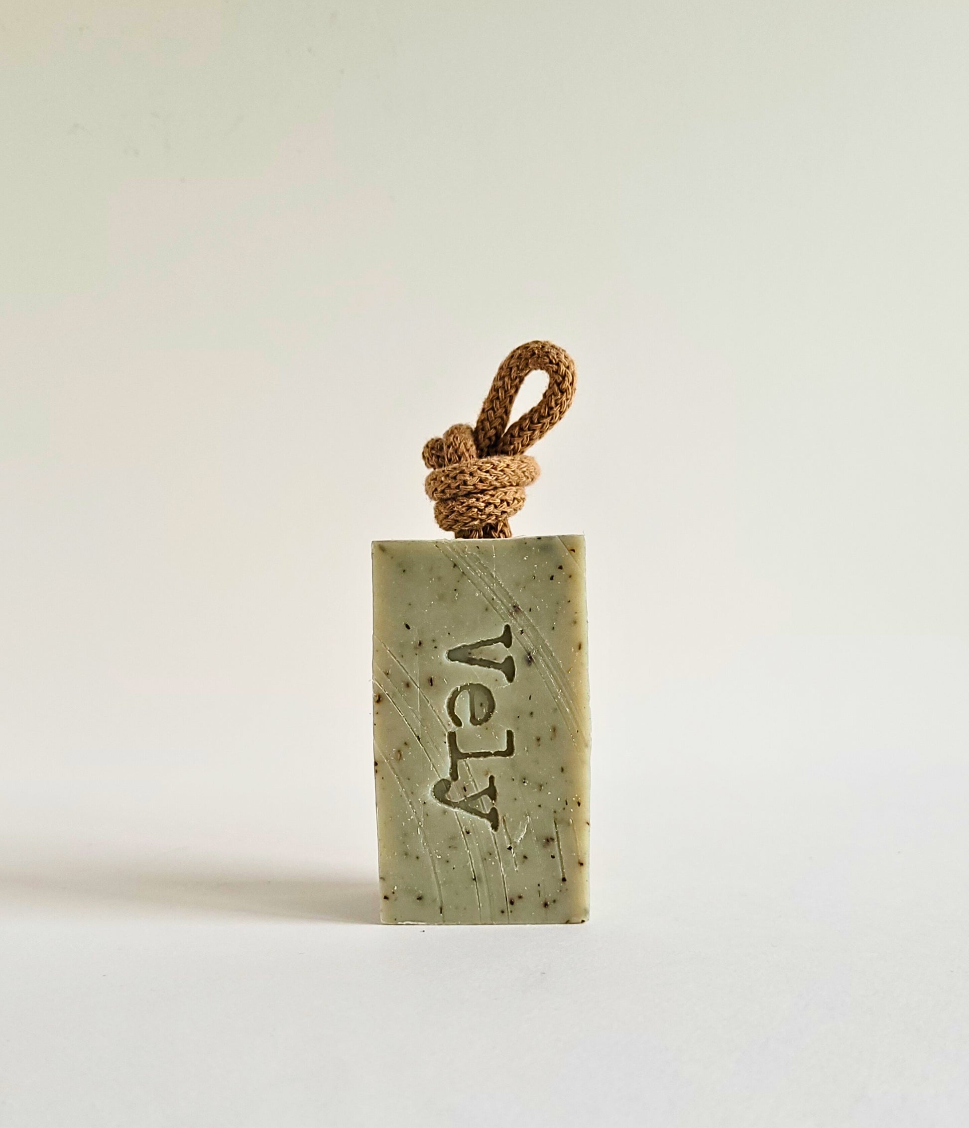 green soap bar with brown rope  and the word Vely etched into the bar