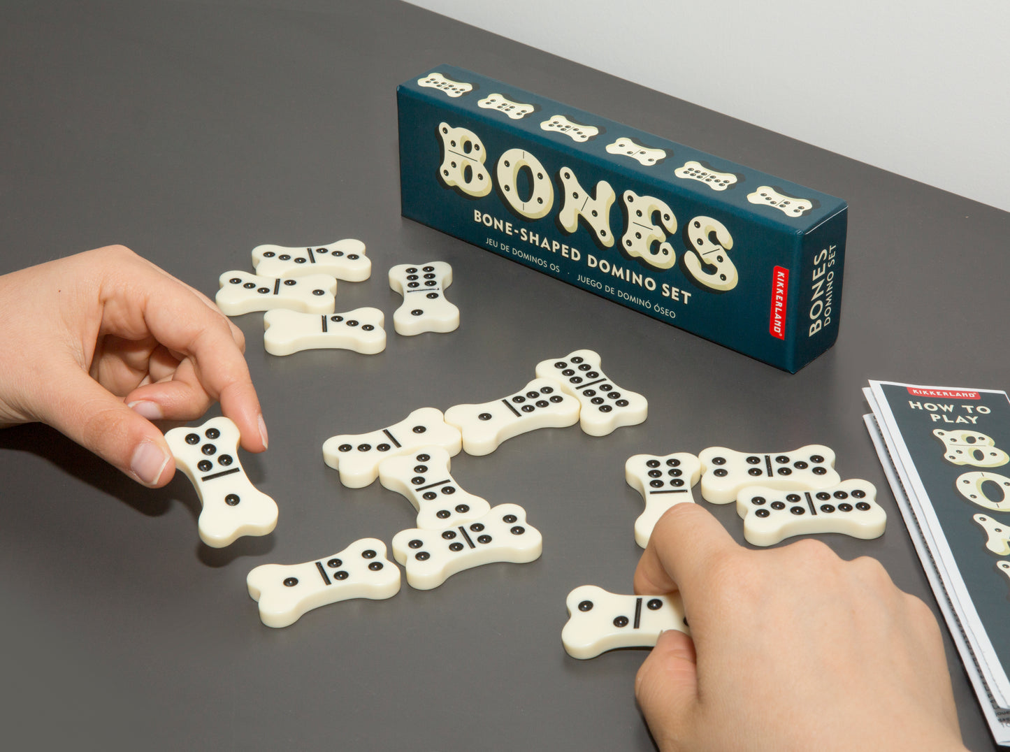 a person playing dominoes with the bone dominoes