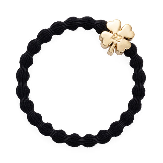 black hair band with a gold clover leaf motif