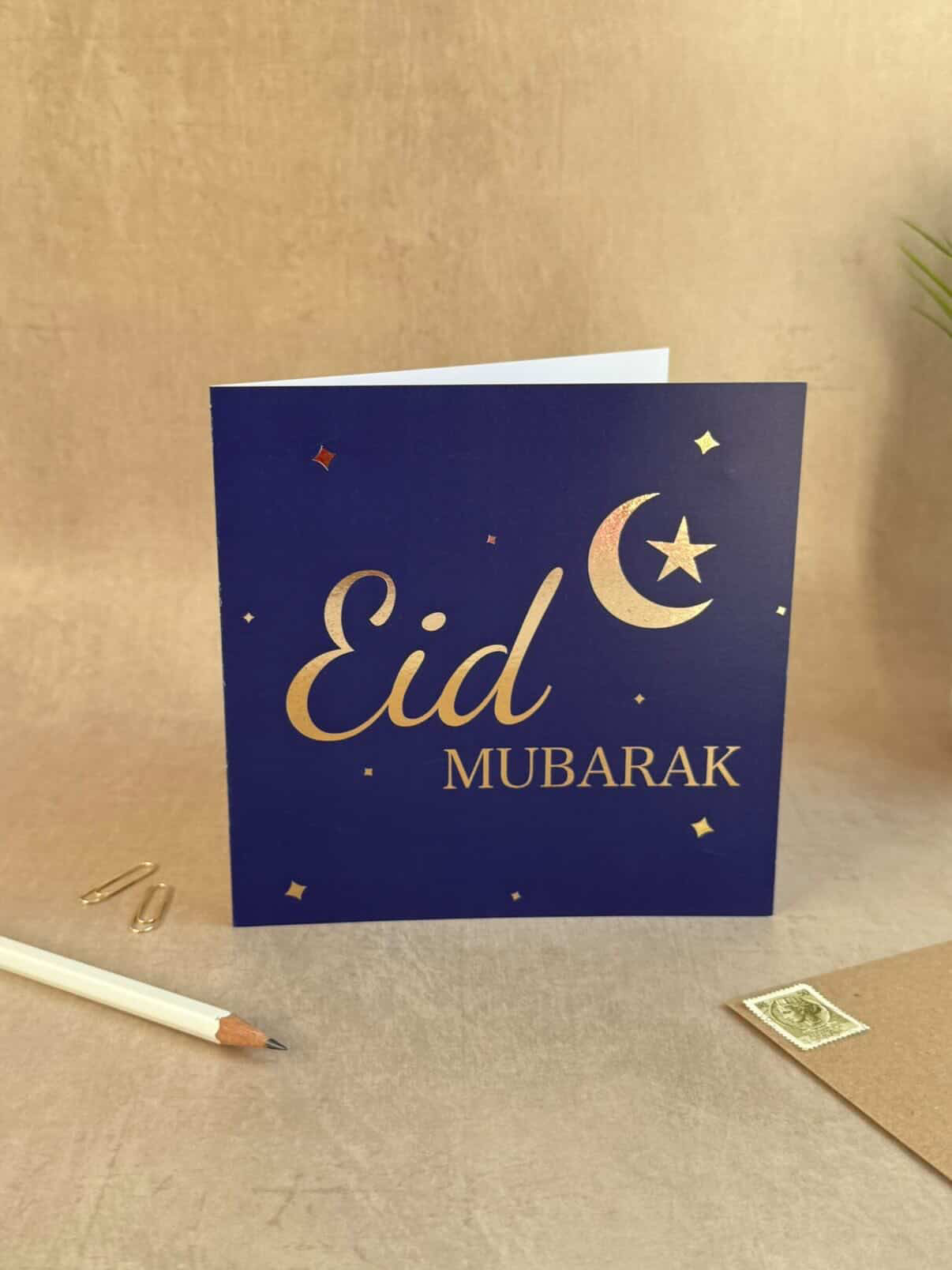 Eid Mubarak card with a moon and star design on a beige background