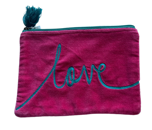 Pink pouch with 'love' embroidery on a light blue background