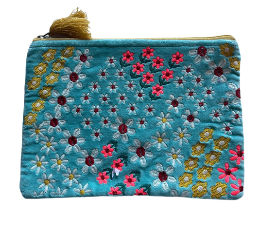 Embroidered pouch with floral patterns on a light blue background