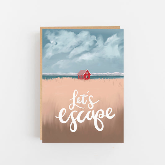 Greeting card with the words Let's Escape on the front in white background pale beige field with a small terracota house in the background with the sea and sky of clouds behind this. brown kraft envelope