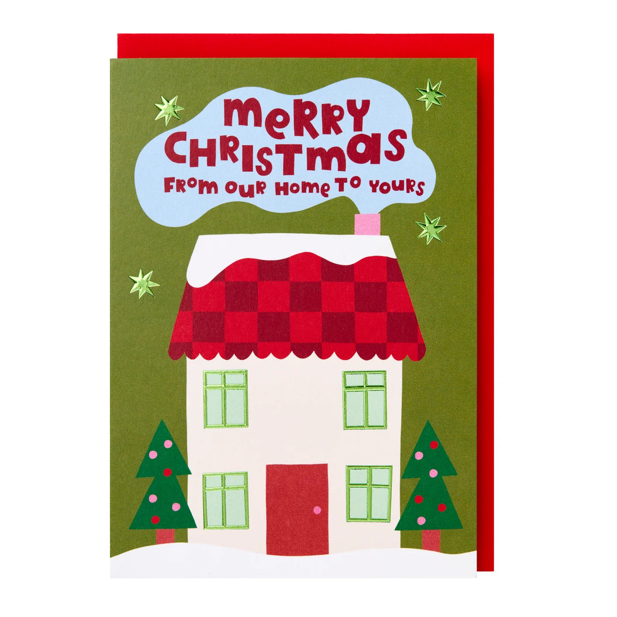 A Christmas greeting card featuring a hand-drawn house with a red checkered roof, green trees, and a blue cloud-shaped area with the text 'Merry Christmas From Our Home To Yours'. A red envelope is partially visible behind the card.