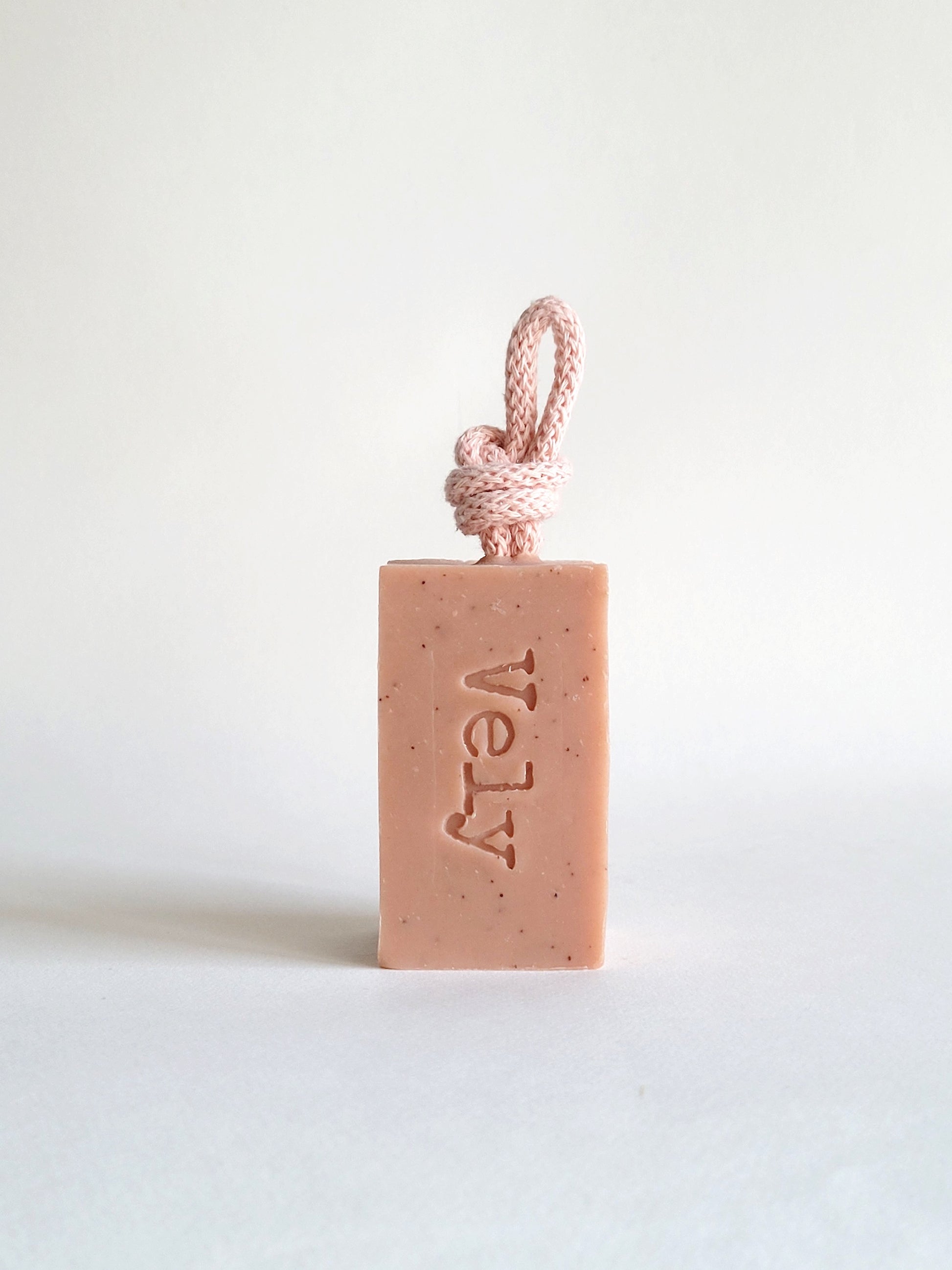 Pink soap with pink rope. the fragrance is amelie. The word Vely is etched into the soap bar
