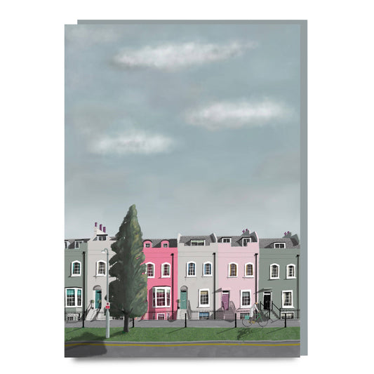 Illustration of a row of colorful houses with a tree in the foreground on a light blue sky background.