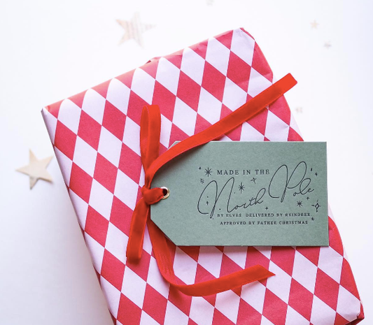 set of 3 christmas gift tags each has Made in the north pole written on one side. the base colour is dark grey and the writing is in black