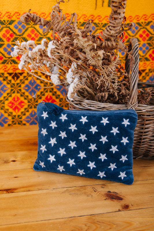 Dark Blue Velvet Material Pouch with zip and Dark Blue Tassel on the zip. Sliver Stars on the front of the pouch 