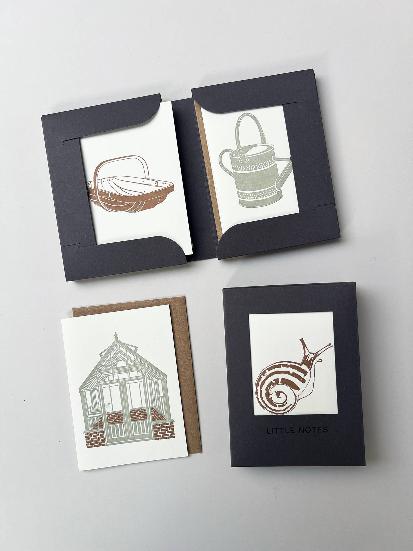 Set of four greeting cards with nature-themed illustrations on a light gray background