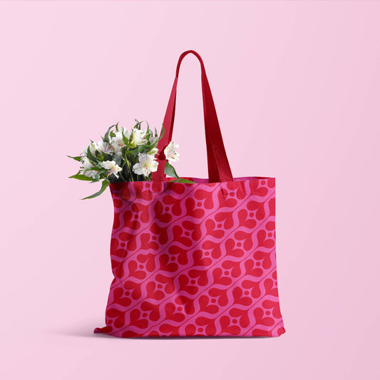 pink and red abstract tulip design on a totebag with red handles 