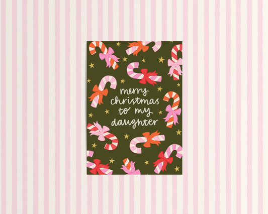 Christmas card with candy canes and bows on a striped background