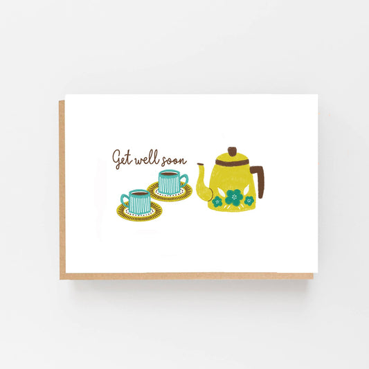 Greeting card  featuring a hand drawn Kettle alongside 2 cups and saucers. Above the cups  are the words Get Well Soon. The card is blank inside for your own message and comes with a kraft envelope.