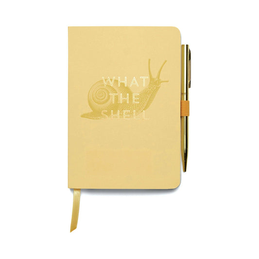 image shows an a5 pale yellow notebook with an image of hand drawn snail in brown. across the middle of the snail are the words what the shell in gold foil. on the right hand side of the notebook in the middle is a loop of yellow elastic which is holding a gold ball point pen. 