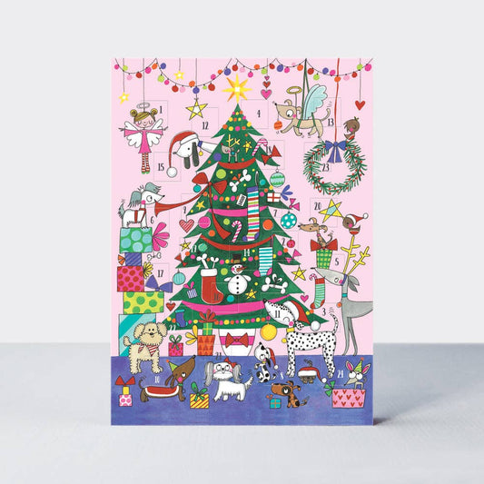Colorful Christmas-themed card with a tree, presents, and various festive elements on a pink background.
