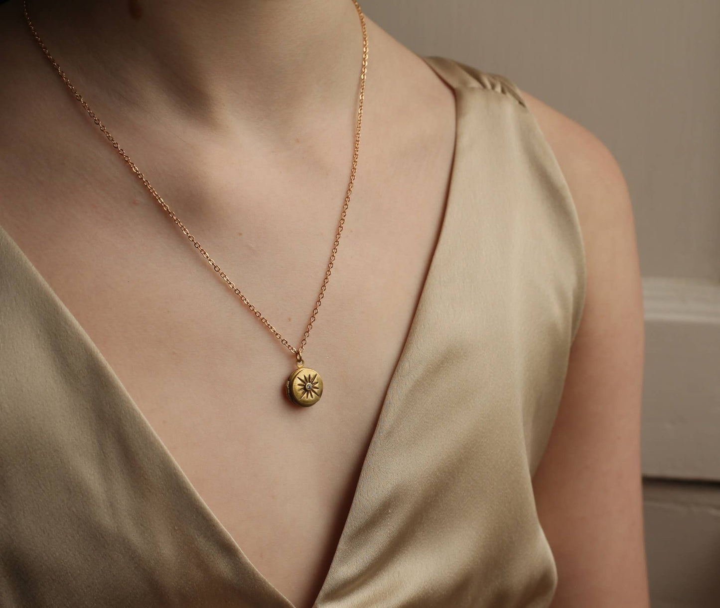image of a lady wearing the compass locket